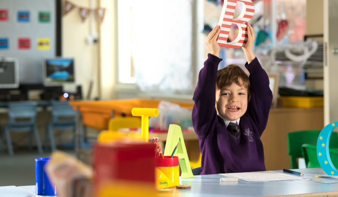 wycliffe ursery pupil playing with wooden letters