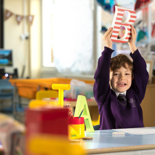 wycliffe ursery pupil playing with wooden letters