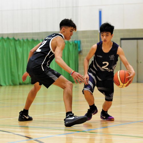 a pair of wycliffe students playing basketball