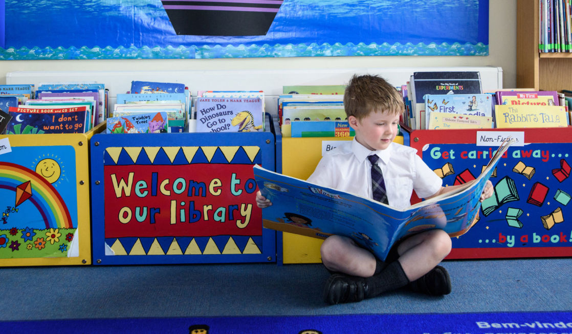 wycliffe nursery pupil reading a book