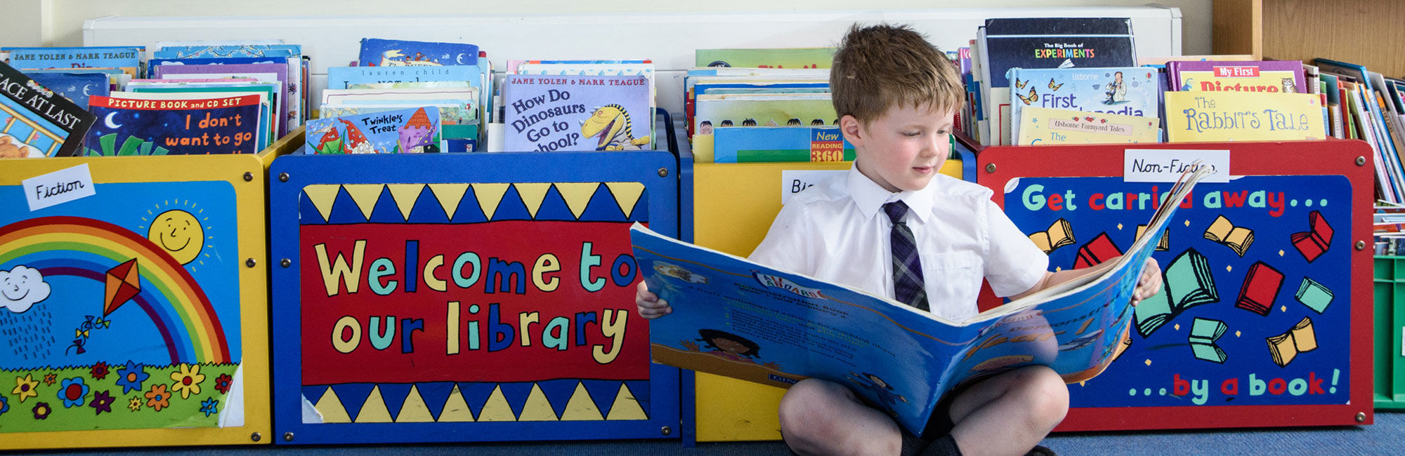 wycliffe nursery pupil reading a book