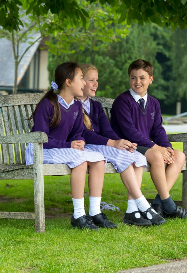 wycliffe pupils sitting on a bench