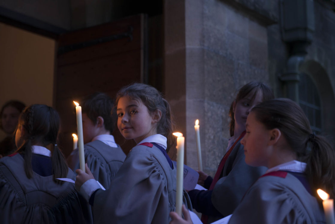 wycliffe pupils walking into a chapel holding candles