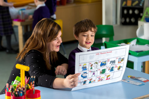 wycliffe teacher and student reading a phonics chart