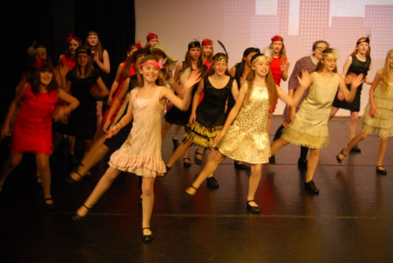 wycliffe girls in costumes dancing onstage