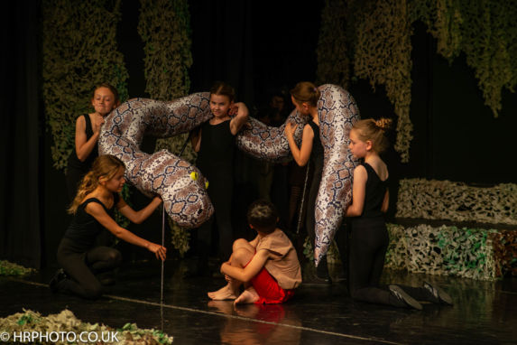 wycliffe pupils using a prop snake on a stage