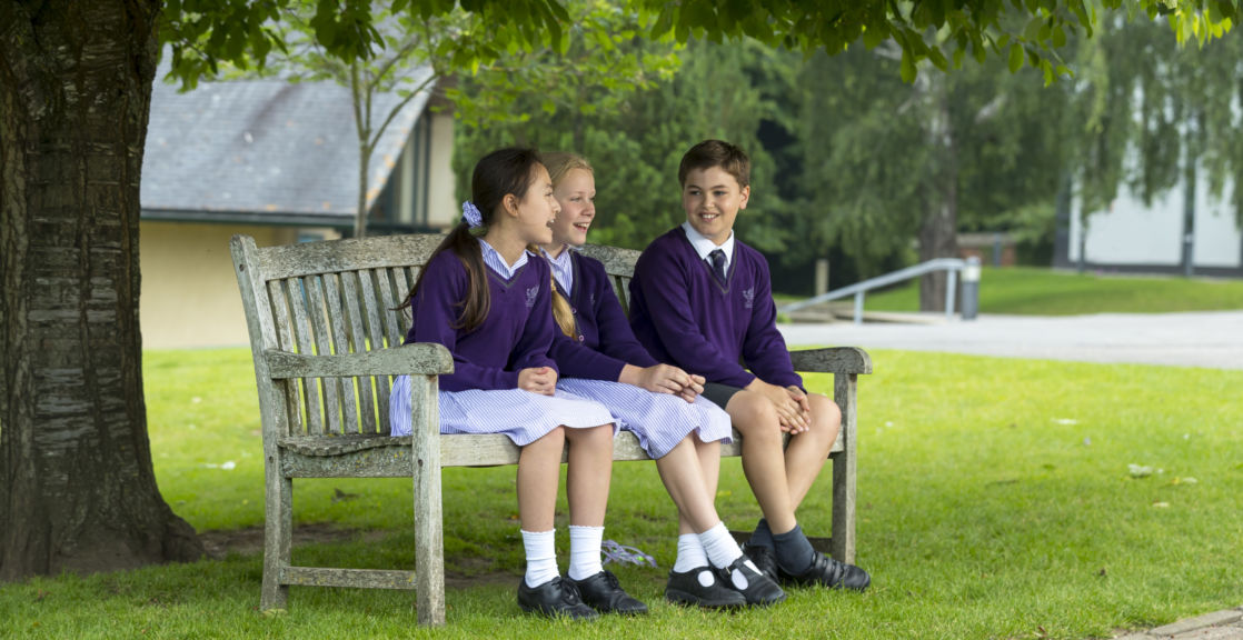 wycliffe kids sitting on a bench outdoors