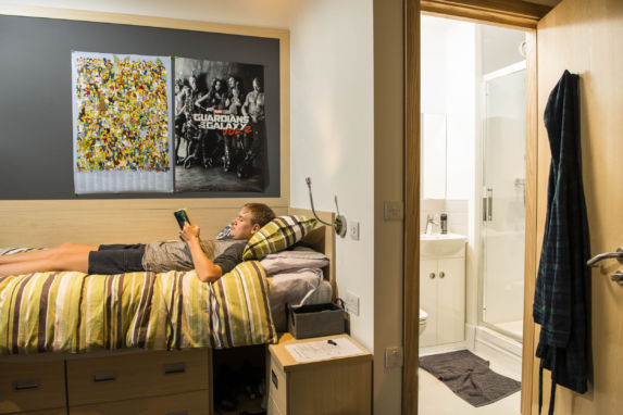 wycliffe pupil laying on the bed of his room