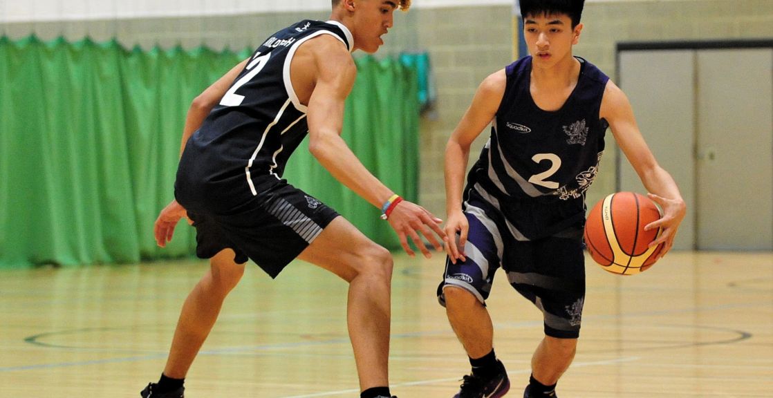 a pair of wycliffe students playing basketball