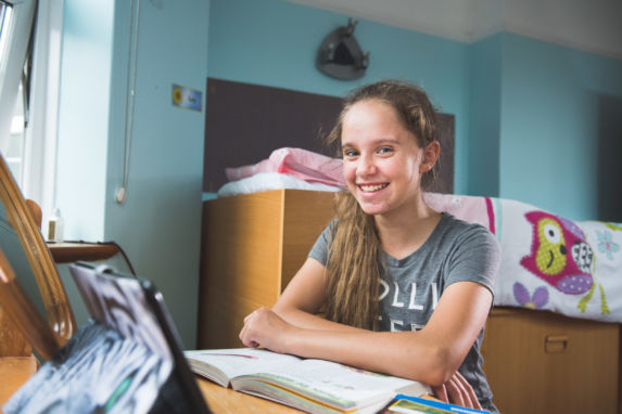 wycliffe girl smiling in her doorm