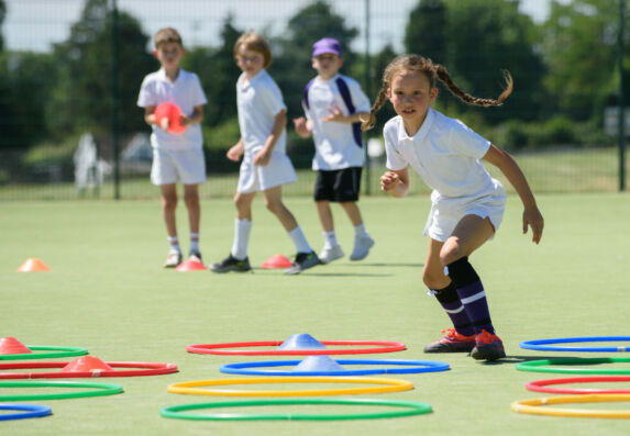 wycliffe girl running between hula hoops