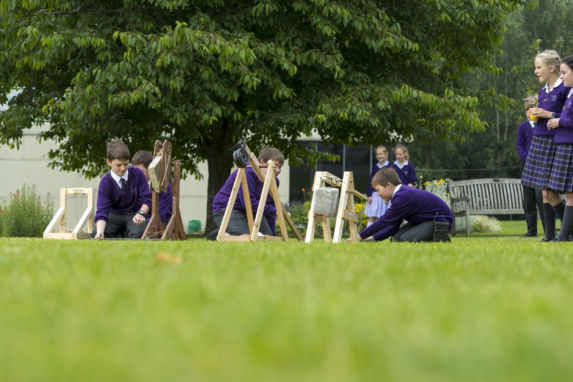 wycliffe kids playing with tools outside