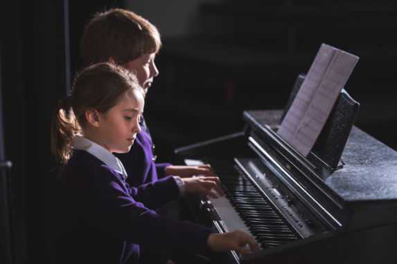 wycliffe kids playing the piano