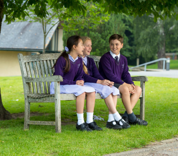 wycliffe pupils sitting on a bench