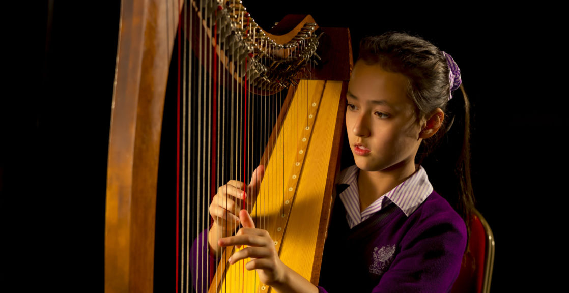 Wycliffe student play the harp music instrument