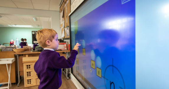 wycliffe pupil playing with smart board