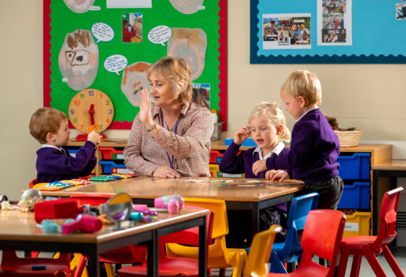 nursery wycliffe kids and teacher playing in class