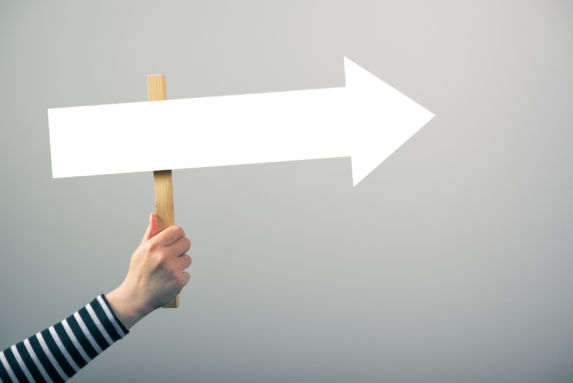 woman holding directional signage