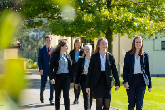 Wycliffe sixth form uniform pupils outside walking