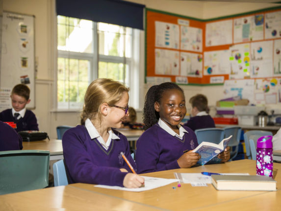 wycliffe girls smiling and reading in class